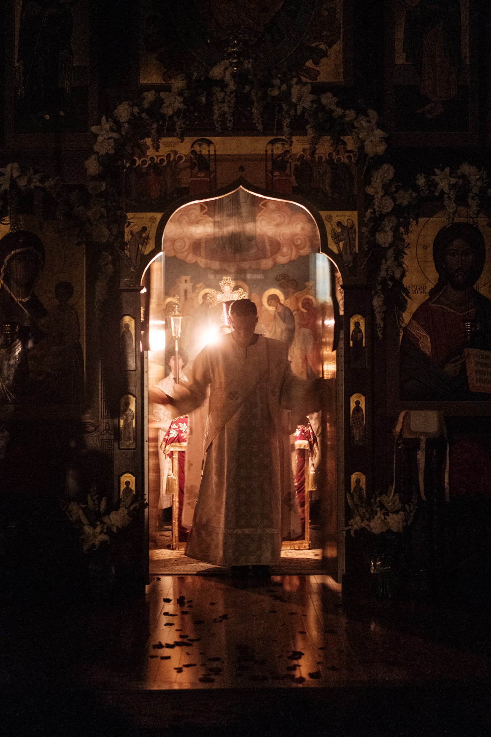 The Royal Doors of the iconostasis by candlelight during the Divine Liturgy